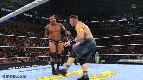 A Man In A Wrestling Ring With A Gatorade Bottle Behind Him GIF