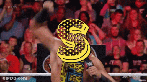 A Man In A Wrestling Ring With A Letter S On His Head GIF