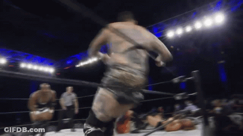 A Man In A Wrestling Ring With A Referee GIF