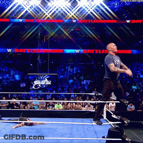 A Man In A Wrestling Ring With A Sign That Says Battleground In The Background GIF