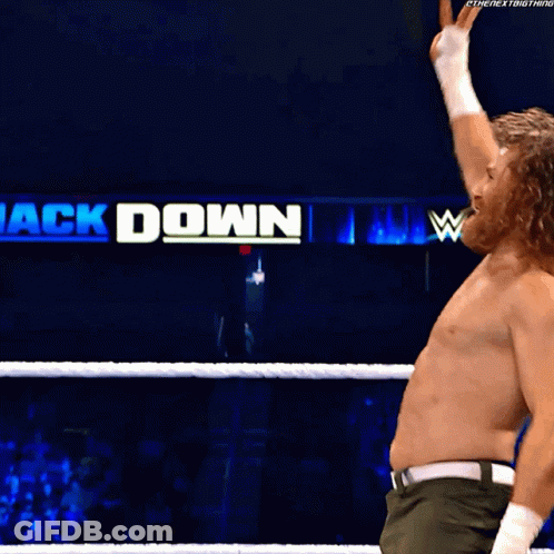 A Man In A Wrestling Ring With A Sign That Says ' Ck Down ' GIF