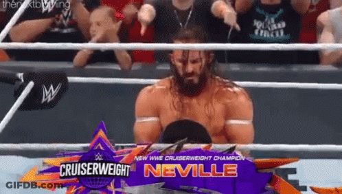 A Man In A Wrestling Ring With A Sign That Says Cruiserweight Neville On It GIF