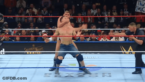 A Man In A Wrestling Ring With A Sign That Says Saturday Night 'S GIF