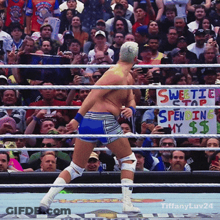 A Man In A Wrestling Ring With A Sign That Says Sweetie Stap Spending My $$ GIF