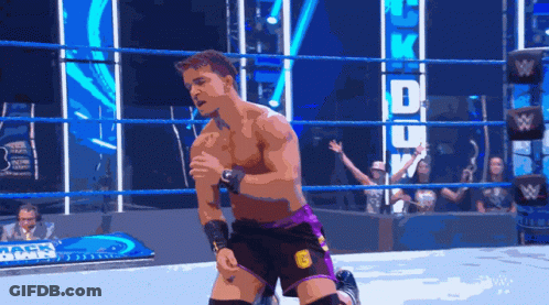 A Man In A Wrestling Ring With A Sign That Says UFC GIF