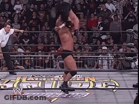 A Man In A Wrestling Ring With A Sign That Says ' Wrestling ' GIF