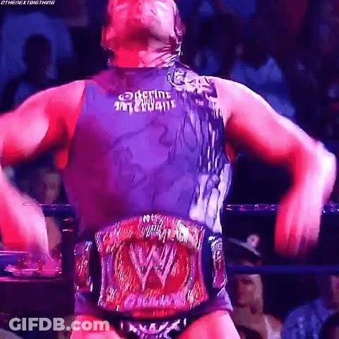 A Man In A Wrestling Ring With A W Belt Around His Waist .. GIF