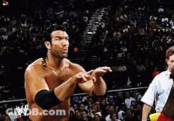 A Man In A Wrestling Ring With A W Logo On His Arm GIF