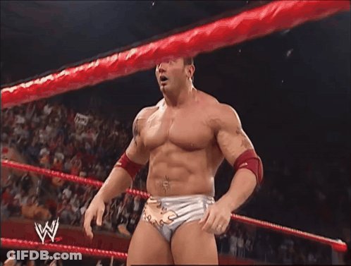 A Man In A Wrestling Ring With A W Logo On His Belt GIF