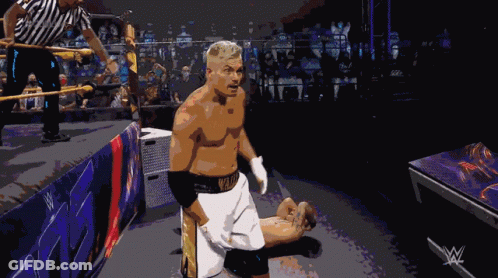A Man In A Wrestling Ring With A W Logo On The Corner GIF