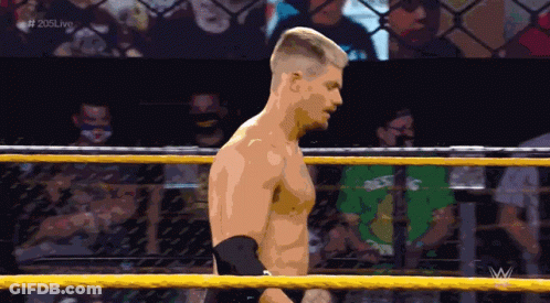 A Man In A Wrestling Ring With The Hashtag # 205Live At The Top GIF
