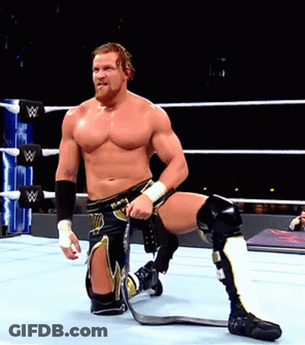 A Man In A Wrestling Ring With The Letter W On The Ring Ropes GIF