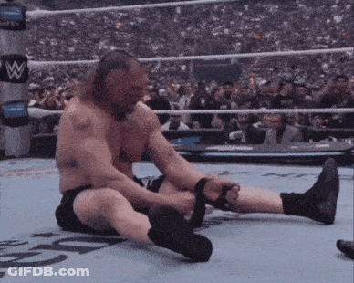 A Man In A Wrestling Ring With The Letter W On The Wall GIF