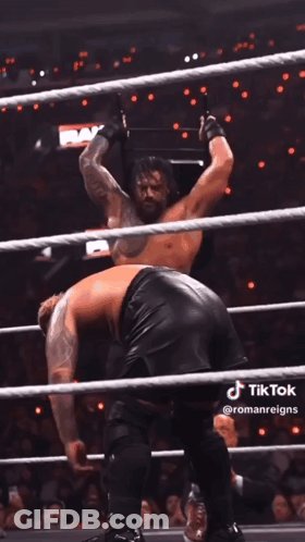A Man In A Wrestling Ring With The Word Raw On The Wall Behind Him GIF