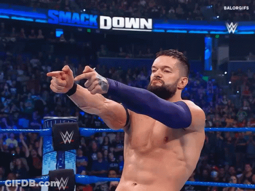 A Man In A Wrestling Ring With The Word Smack Down On The Wall Behind Him GIF