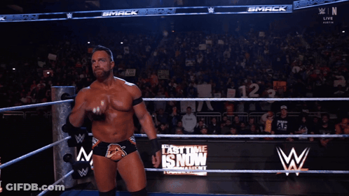 A Man In A Wrestling Ring With The Word Yeah On His Chest GIF