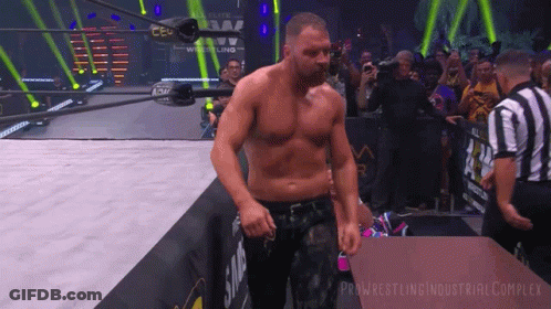 A Man In A Wrestling Ring With The Words Pro Wrestling Industrial Complex Written On The Bottom GIF