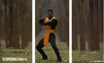 A Man In A Yellow And Black Costume Is Holding A Sword In A Forest . GIF