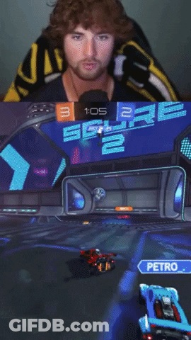 A Man In A Yellow And Black Shirt Is Playing A Video Game GIF