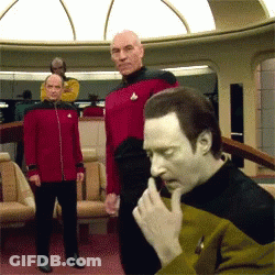 A Man In A Yellow And Black Uniform Has A Star Trek Logo On His Shirt GIF