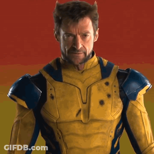 A Man In A Yellow And Blue Superhero Costume GIF