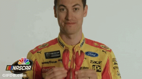 A Man In A Yellow And Red Ford Shirt Is Holding A Lobster GIF