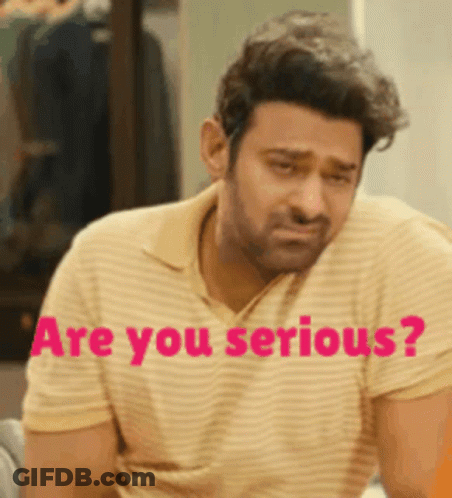 A Man In A Yellow And White Striped Shirt Is Sitting Down With The Words Are You Serious Behind Him . GIF