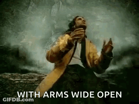A Man In A Yellow Coat And Tie Is Standing In Front Of A Waterfall And Holding A Microphone . GIF
