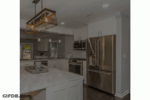 A Man In A Yellow Hard Hat Is Working On A Wooden Beam GIF