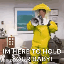 A Man In A Yellow Hazmat Suit Is Holding A Megaphone And Shouting . GIF