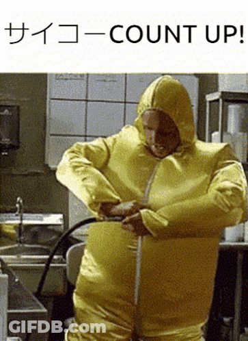 A Man In A Yellow Hazmat Suit Is Measuring His Waist With A Tape Measure GIF