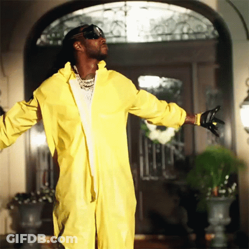 A Man In A Yellow Hazmat Suit Is Standing In Front Of A Door GIF