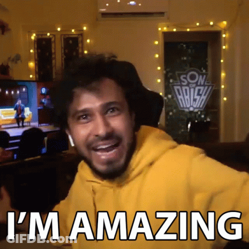 A Man In A Yellow Hoodie With The Words I 'M Amazing On The Bottom GIF
