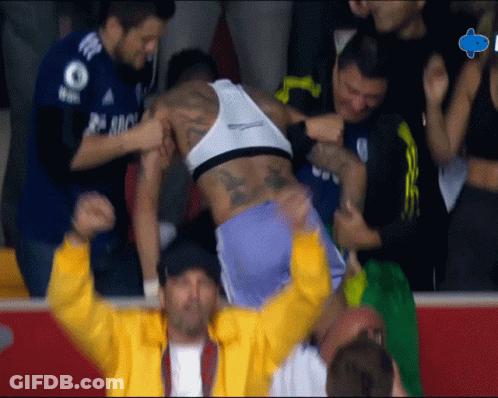 A Man In A Yellow Jacket Is Holding A Man In A White Tank Top With The Number 8 On It GIF