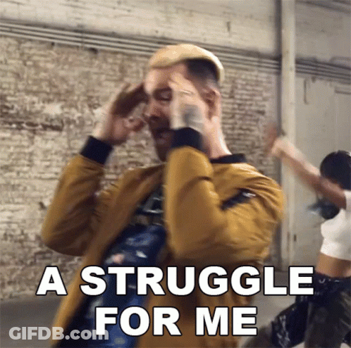 A Man In A Yellow Jacket Is Holding His Head And Says A Struggle For Me GIF