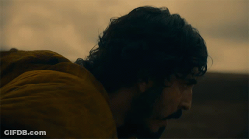 A Man In A Yellow Jacket Is Looking Down GIF