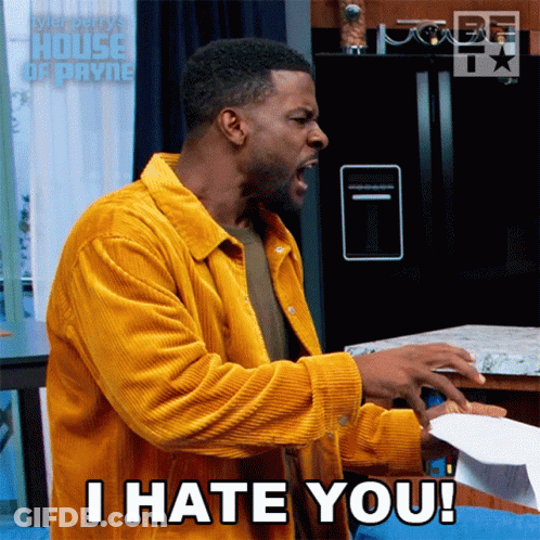 A Man In A Yellow Jacket Is Screaming And Holding A Piece Of Paper That Says I Hate You GIF