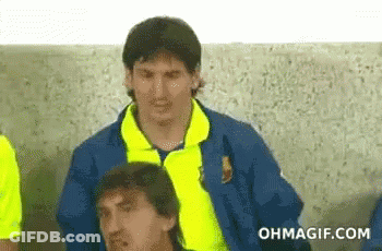 A Man In A Yellow Jacket Is Sitting Next To Another Man In A Blue Jacket . GIF