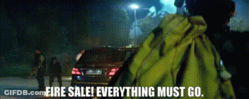 A Man In A Yellow Jacket Stands In Front Of A Car With The Words Fire Sale Everything Must Go GIF