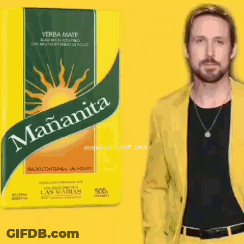 A Man In A Yellow Jacket Stands Next To A Box Of Yerba Mate GIF