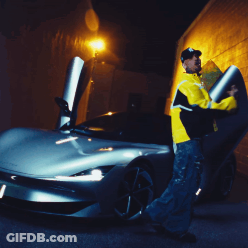 A Man In A Yellow Jacket With The Letter B On It GIF
