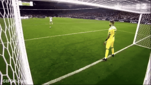 A Man In A Yellow Jersey With The Number 11 On It Is Standing On A Soccer Field GIF