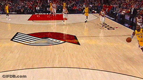 A Man In A Yellow Jersey With The Number 23 On It Dribbles A Basketball GIF