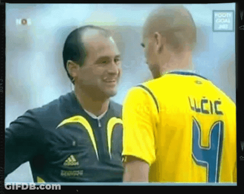 A Man In A Yellow Jersey With The Number 4 On It Is Talking To Another Man GIF