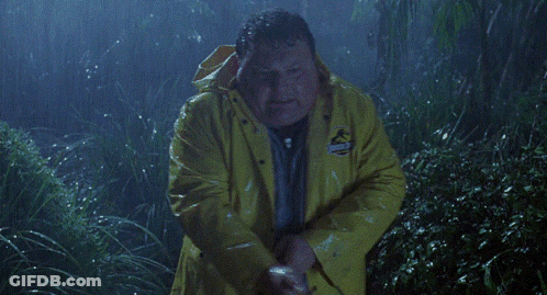A Man In A Yellow Jurassic Park Raincoat GIF