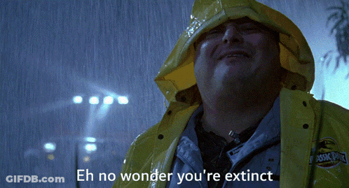 A Man In A Yellow Raincoat Says " Eh No Wonder You 'Re Extinct " In The Rain GIF