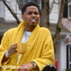 A Man In A Yellow Robe Is Drinking From A Cup GIF