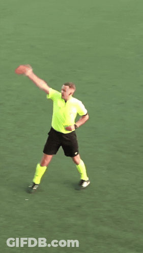 A Man In A Yellow Shirt And Black Shorts Is Holding A Frisbee In His Hand GIF