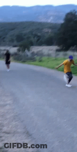 A Man In A Yellow Shirt And Blue Hat Is Running GIF