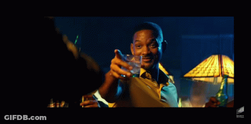 A Man In A Yellow Shirt And Tie Is Holding A Glass Of Water GIF